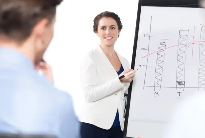 smiling-businesswoman-presenting-chart-audience